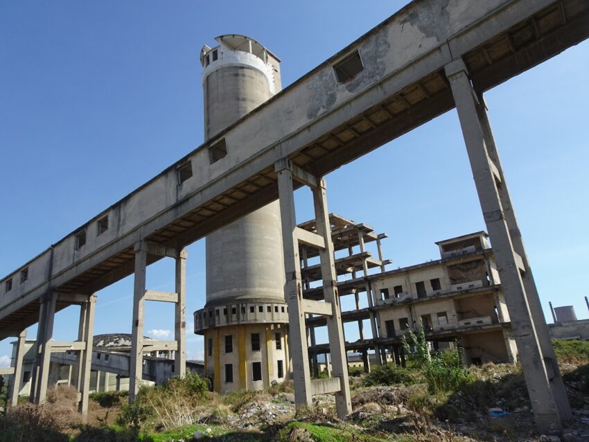 Towers, buildings and a covered walkway at an abanoned power plant