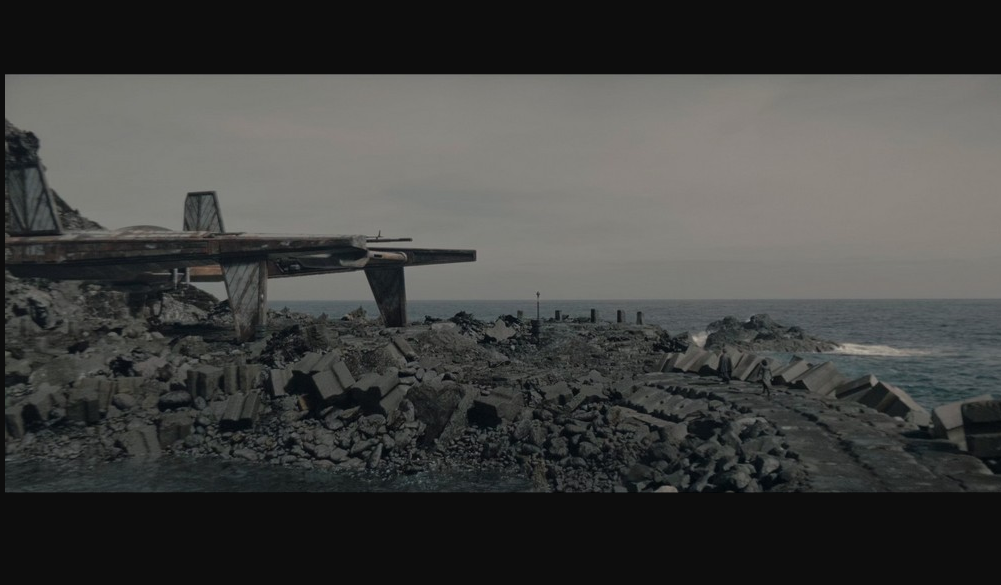 A spaceship on a rocky shore by the sea