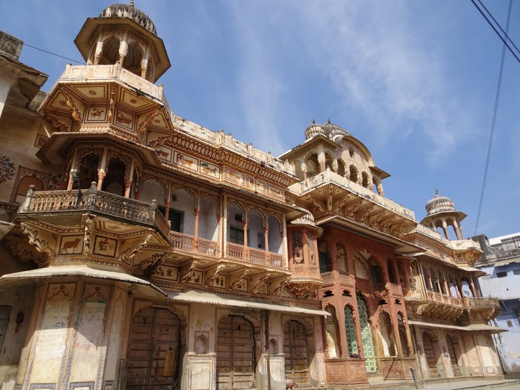 An old haveli building with slender columns and small towers in the streets of Pushkar, Rajasthan